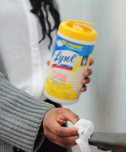 Lysol wipes being used to clean surfaces at home