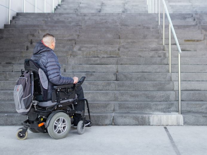 A man utilizing an electric wheelchair