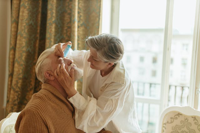 Eye drops being administered into a patient’s eyes