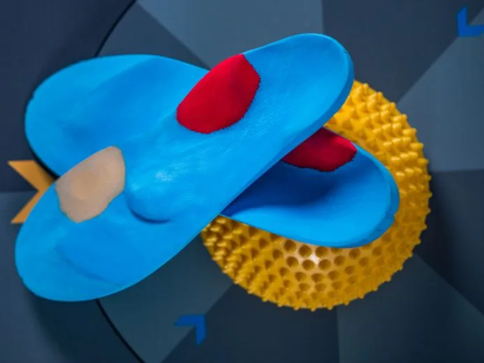 Insoles designed for high arch support paired with a balance pod for foot strengthening exercises